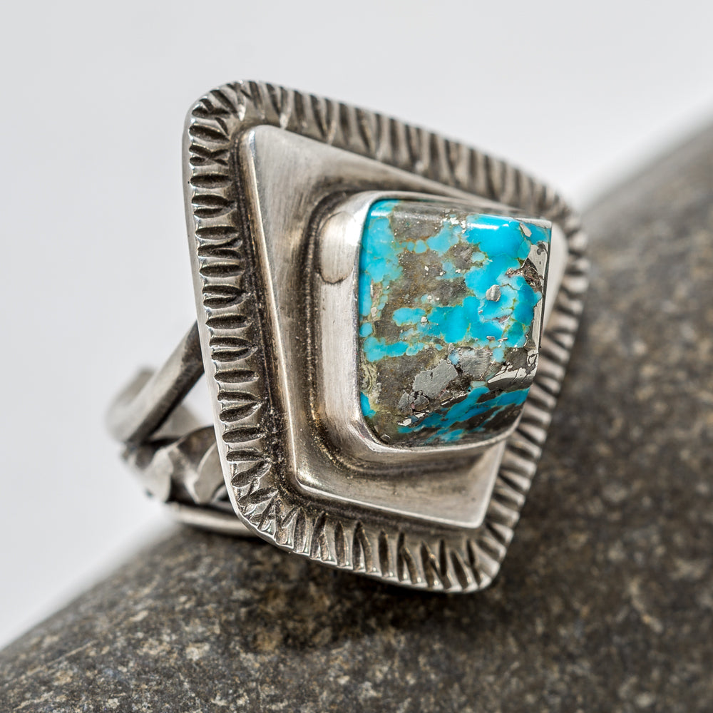 A cabachon of Bisbee turquoise with sterling silver defines a ring by noted internationally known Navajo designer and silversmith Tommy Jackson